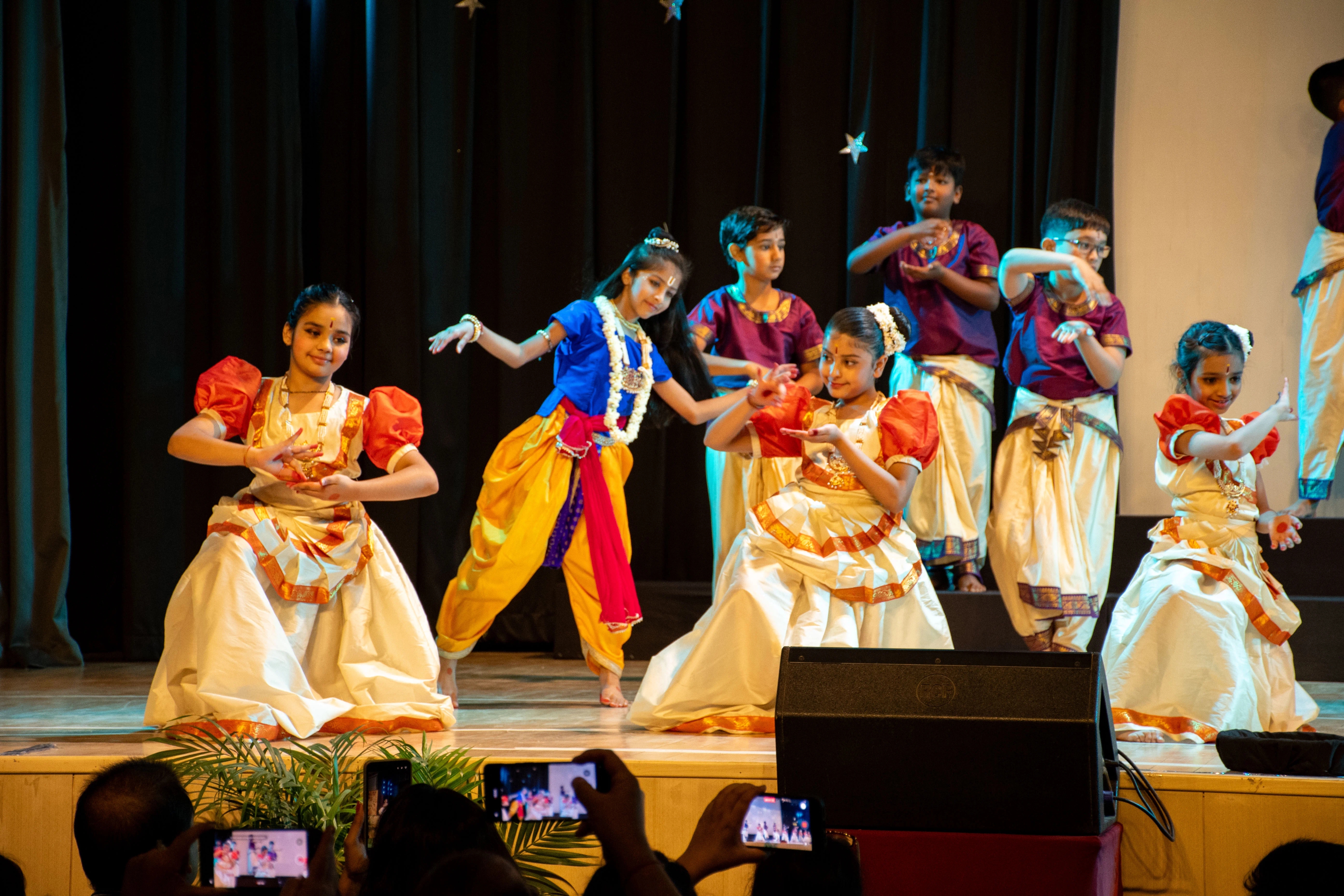Students at a live performance with stage lights at The Shri Ram School