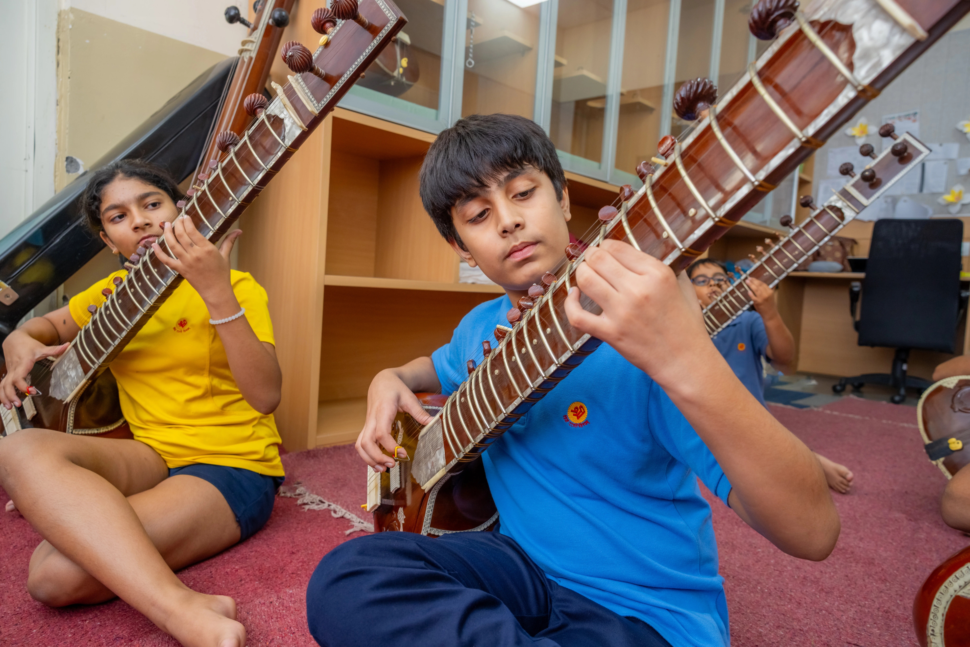 A student playing guitar at The Shri Ram School